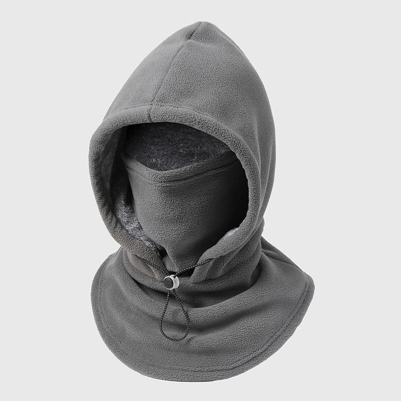 The black Volt Flick 3 in 1 fleece balaclava laid flat on a soft pink field
